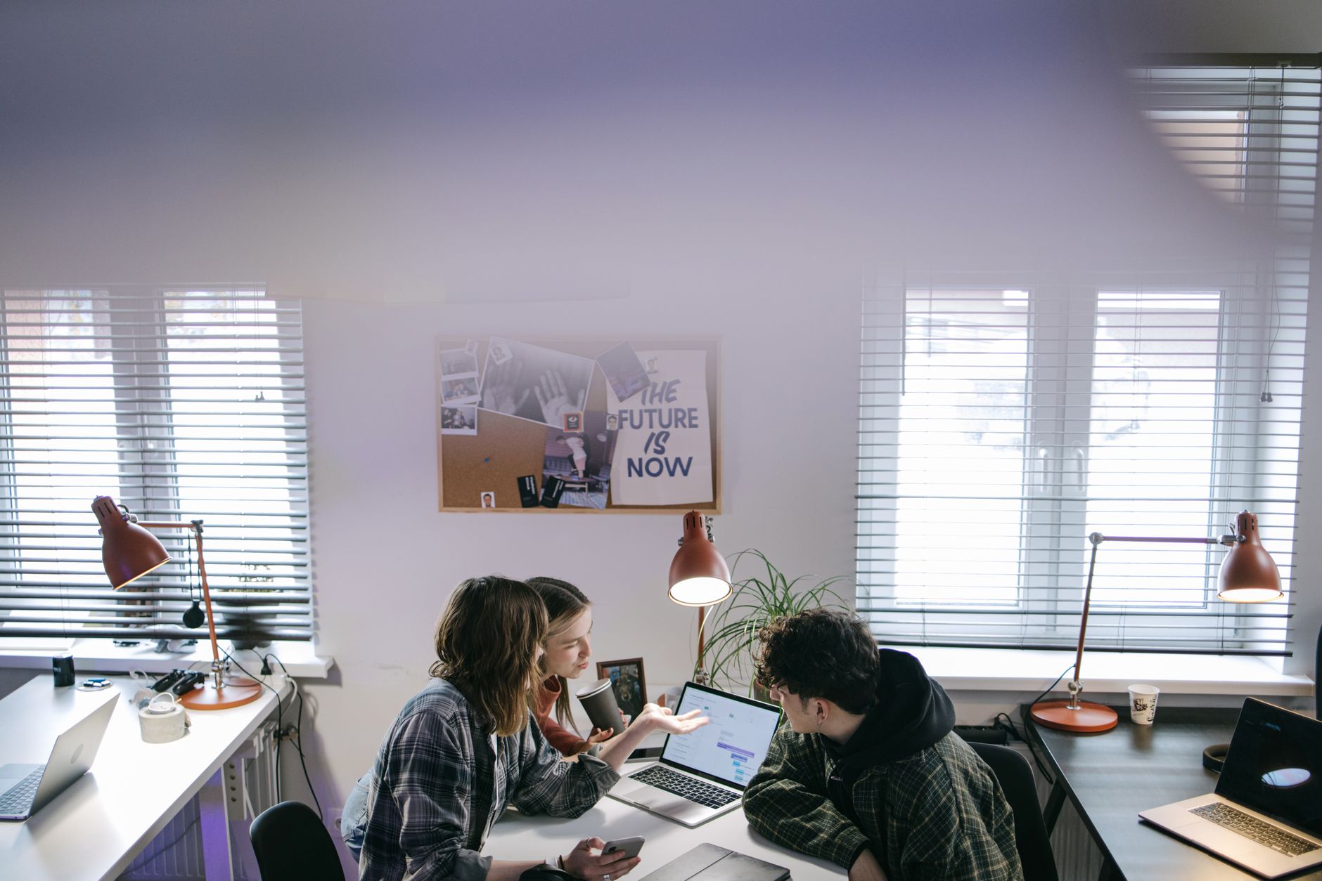 Small business team working together around a laptop
